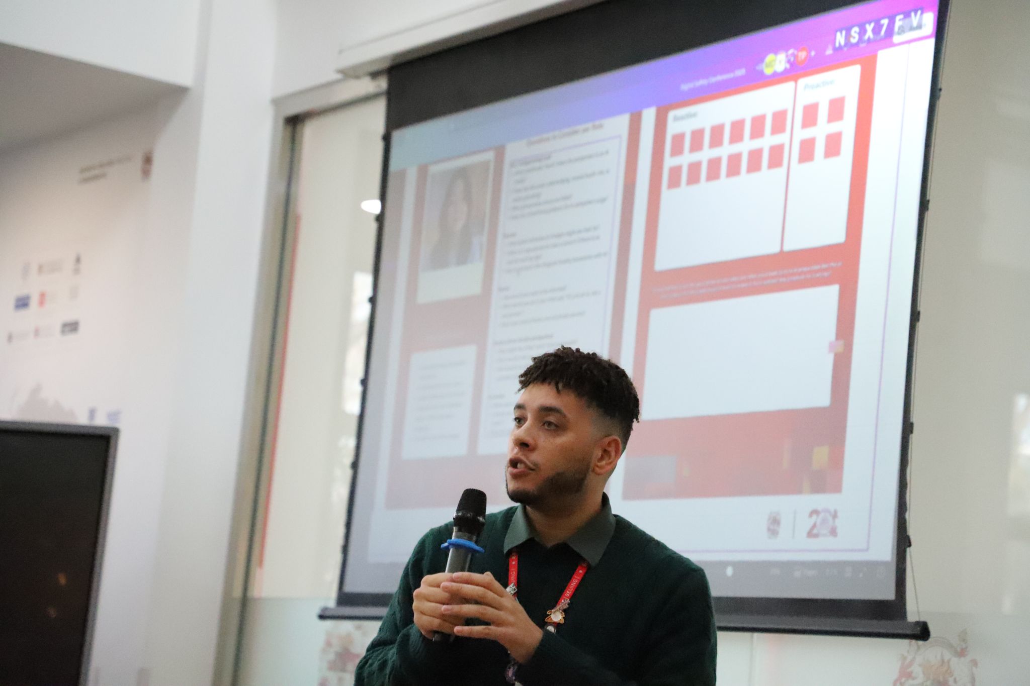 Tim Pyles speaking into a microphone at the Beijing Digital Safeguarding Conference